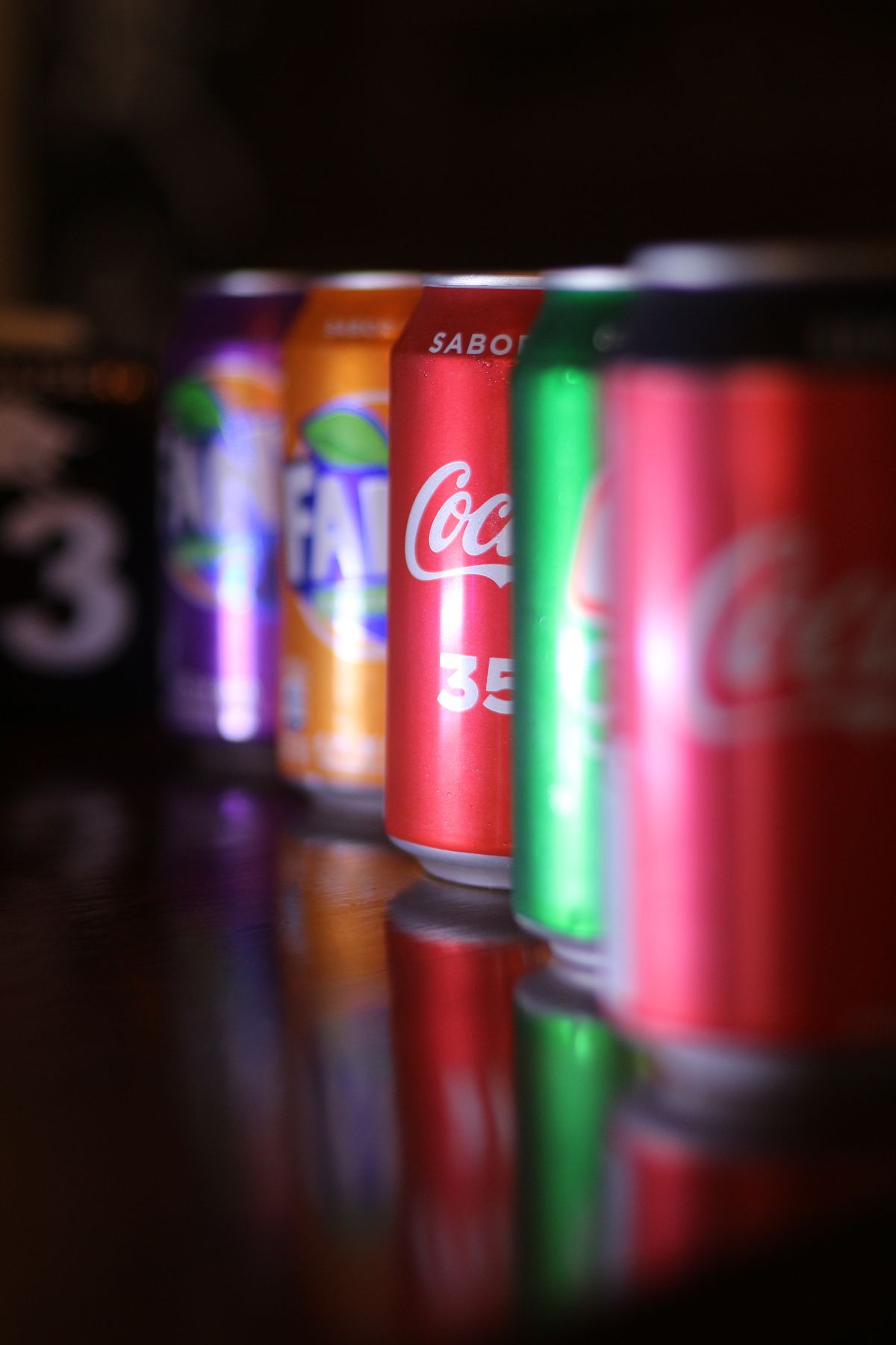 Chilled soft drink cans lined up ready for wholesale distribution